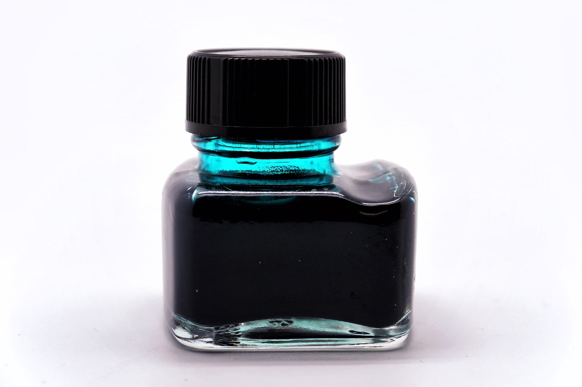 A green glass bottle of fountain pen ink