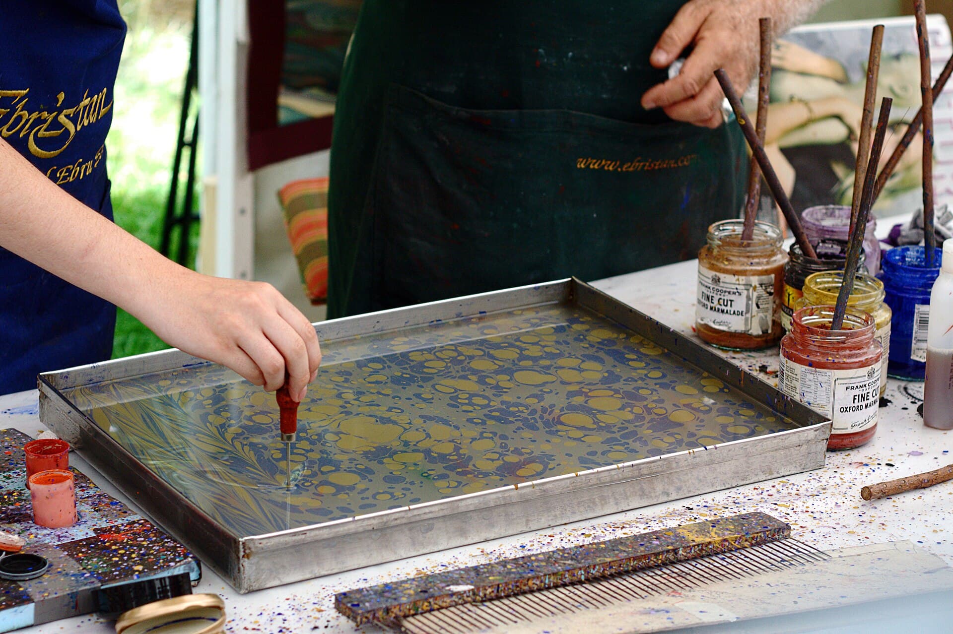 A tank of floating colours used for paper marbling