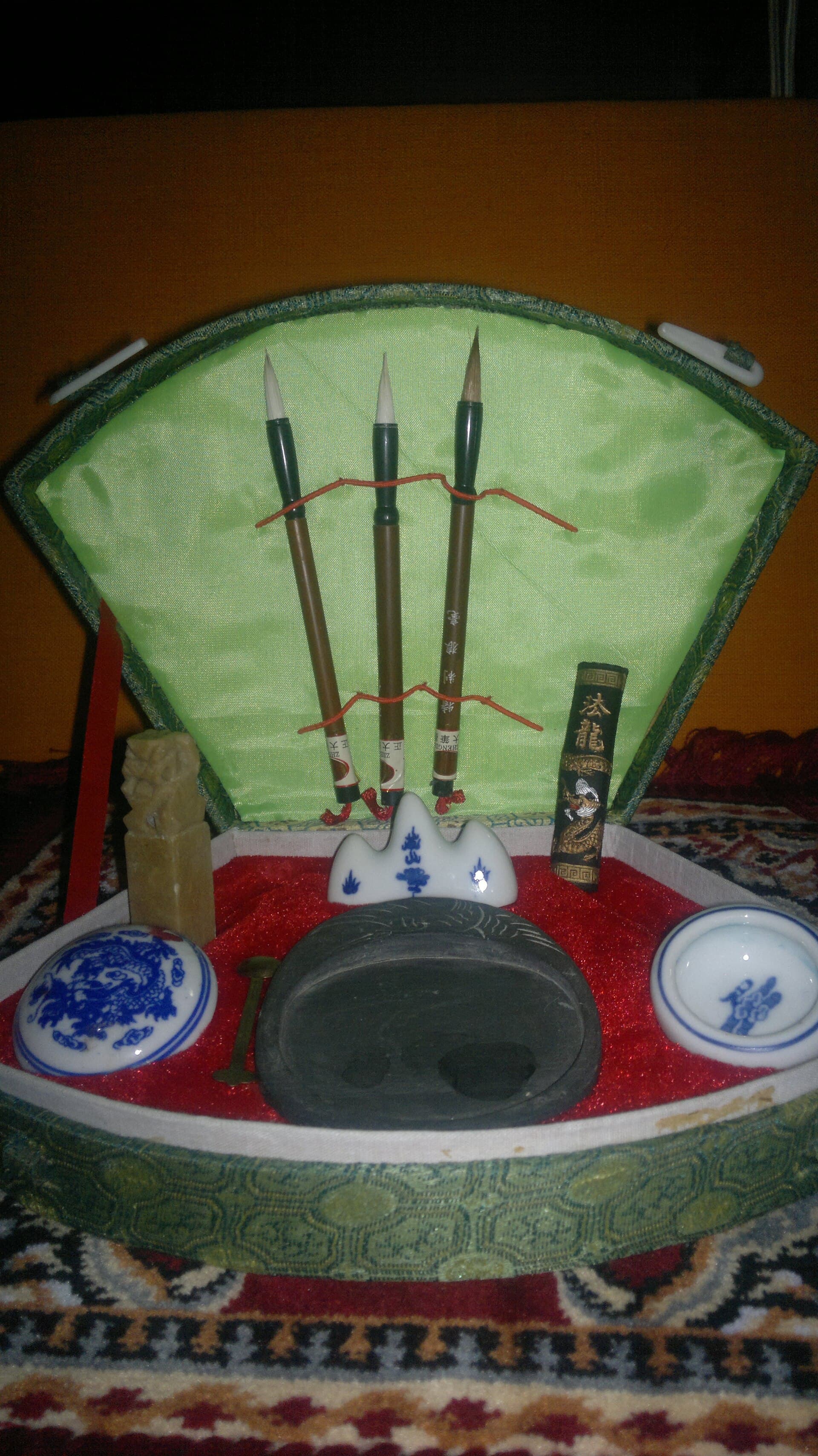 An ink stone, brushes and paper arranged for writing